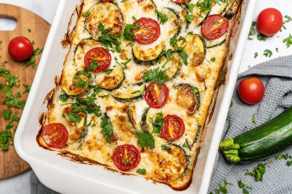 Image of baked zucchini slice with tomato and salami