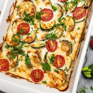 Image of baked zucchini slice with tomato and salami